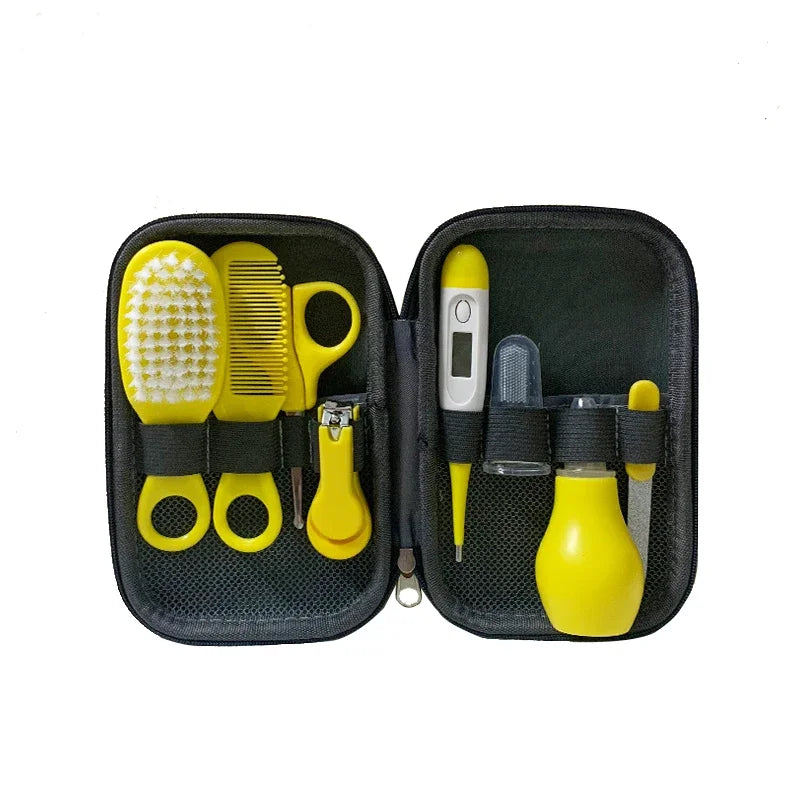 A black zippered baby care kit containing a yellow brush, comb, scissors, nail clippers, thermometer, nasal aspirator, and dropper, neatly organized in elastic loops.