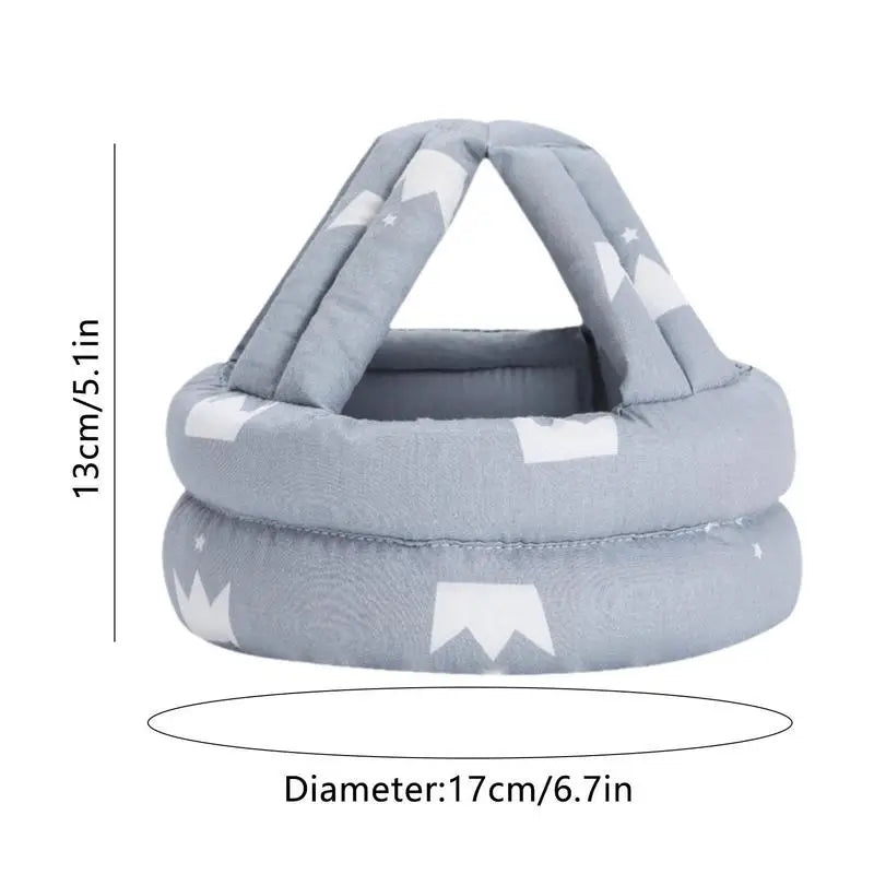 Blue padded head protector for babies with star and mountain patterns, featuring a diameter of 17cm (6.7in) and height of 13cm (5.1in).
