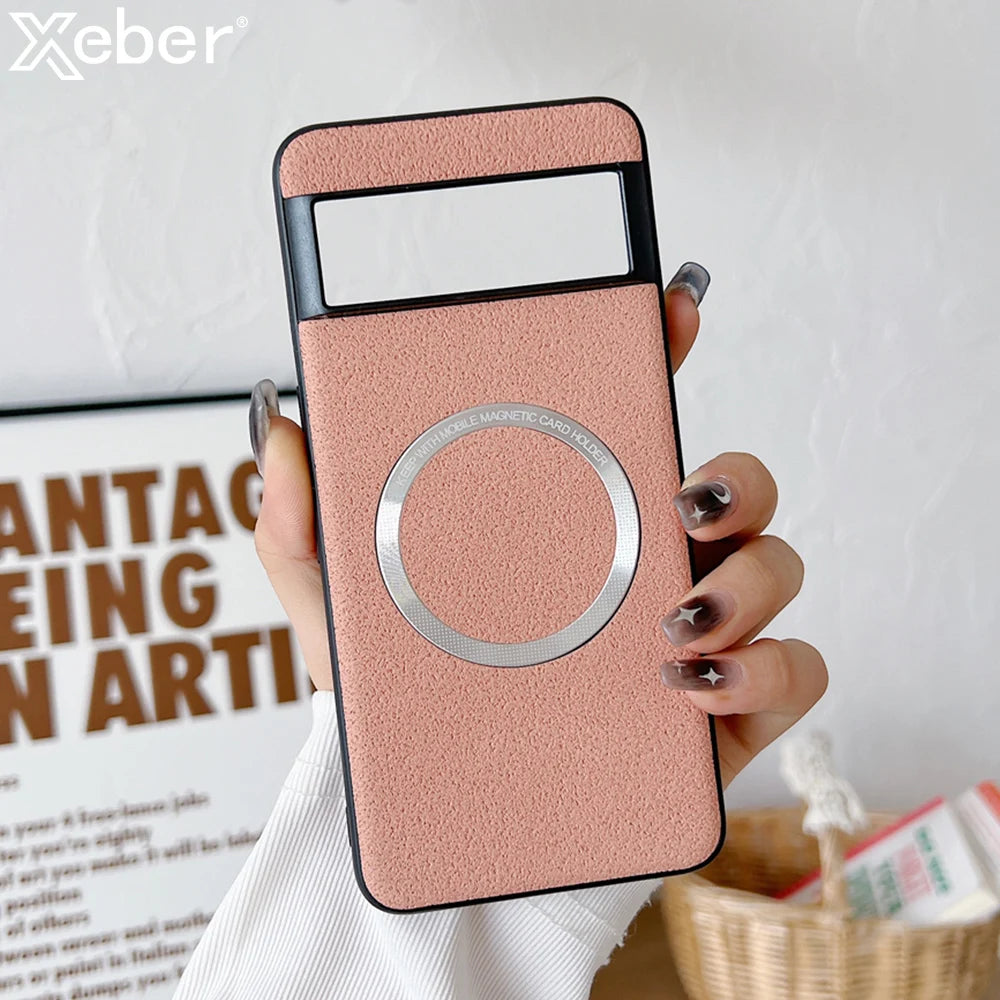 A hand holding a pink smartphone case with a circular metal magnetic holder. The background shows a partial view of wall art and a woven basket with papers.