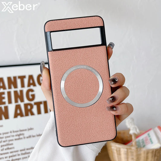 A hand holding a pink smartphone case with a circular metal magnetic holder. The background shows a partial view of wall art and a woven basket with papers.