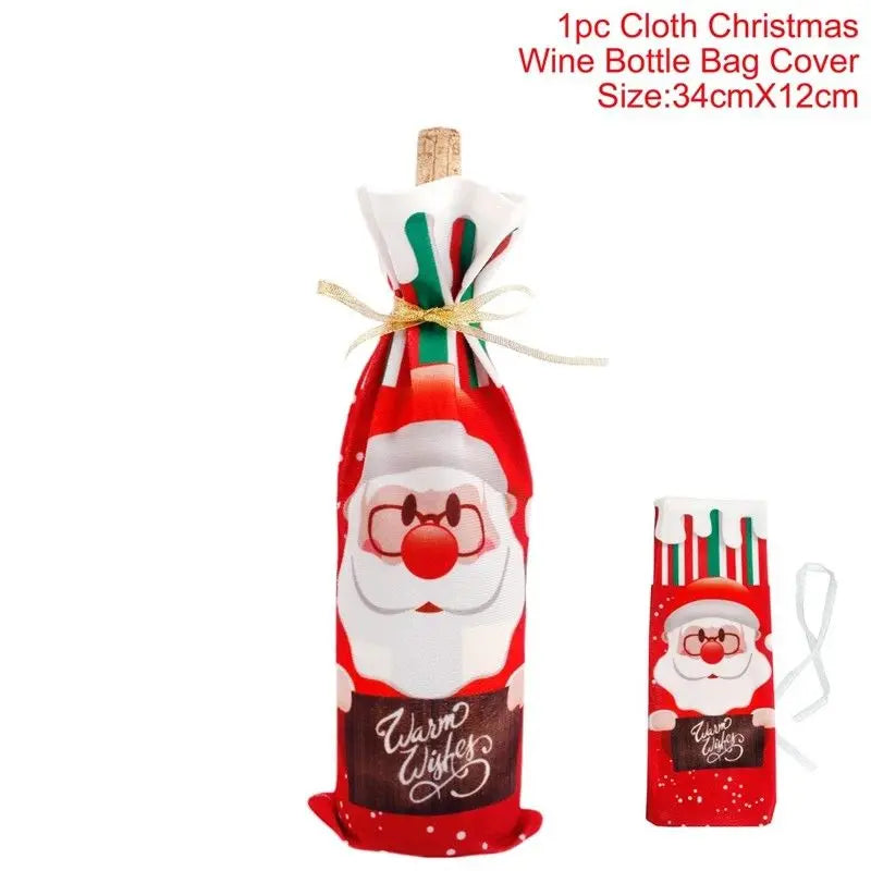 Red cloth wine bottle cover featuring a Santa design with "Warm Wishes" text. Includes a gold ribbon tie and measures 34cm x 12cm. Small gift bag shown on the right.
