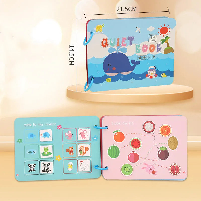 Children's quiet book for ages 3+, featuring a playful whale cover. Open pages show interactive matching and search activities with animals and fruits, sizes 21.5cm x 14.5cm.