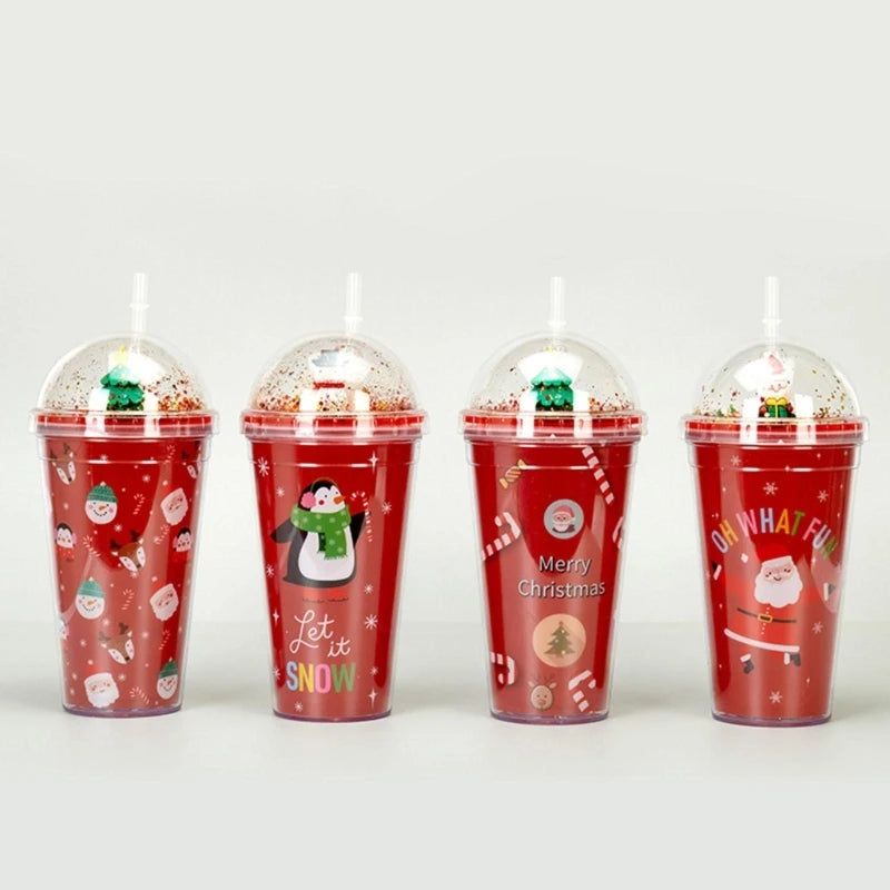 Four red festive cups with dome lids, each featuring Christmas designs: snowmen, penguins, Santa, and candy canes. They have decorative captions like "Let it Snow" and "Merry Christmas."