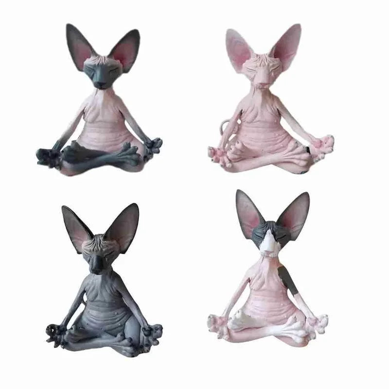 Four hairless cat statuettes in various colors meditate in a seated yoga pose, with large ears and closed eyes, on a plain white background.