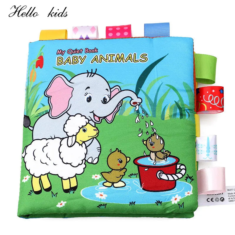 Children's fabric book cover titled "My Quiet Book: Baby Animals" featuring an elephant, lamb, and ducklings playing by a pond. Colorful tabs are attached to the edges.
