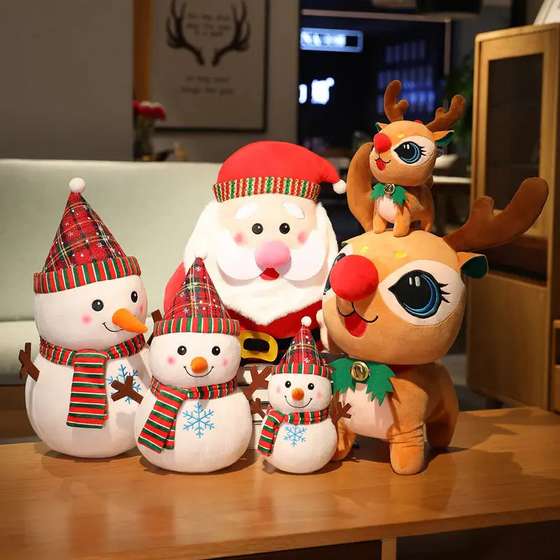 Plush Santa, Rudolph reindeer, and three snowmen with plaid hats and scarves on a wooden table. The scene is festive, with Christmas decorations in the background.