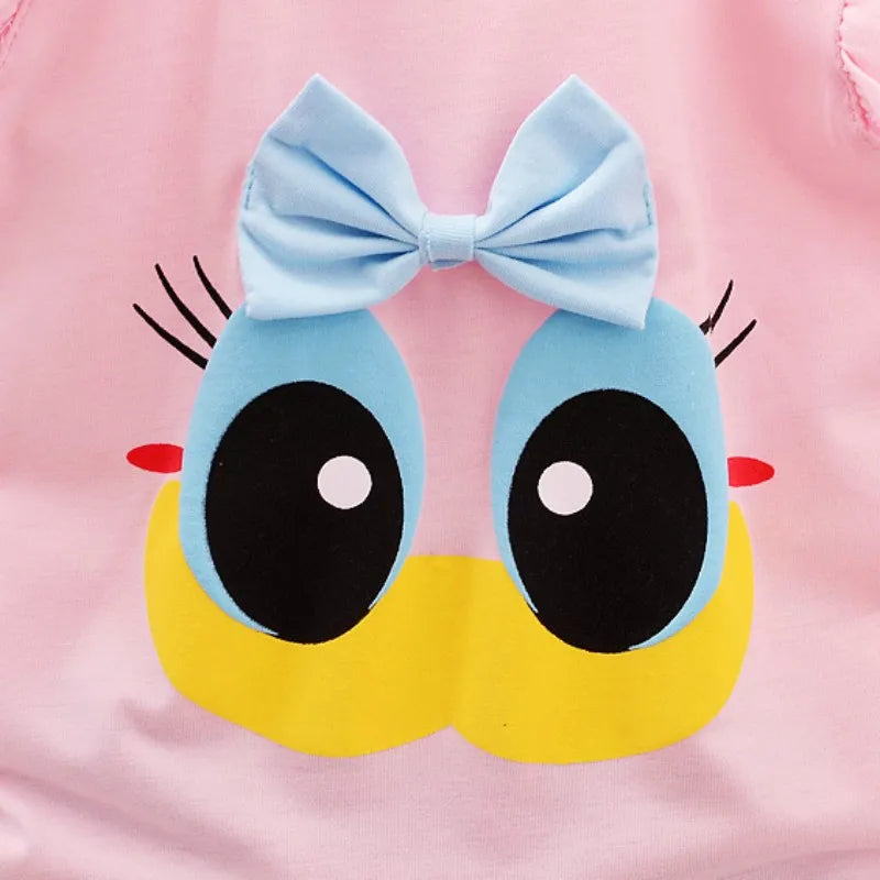 Close-up of a cartoon face on a pink background, featuring large eyes, long eyelashes, a yellow beak, and a blue bow above the eyes.