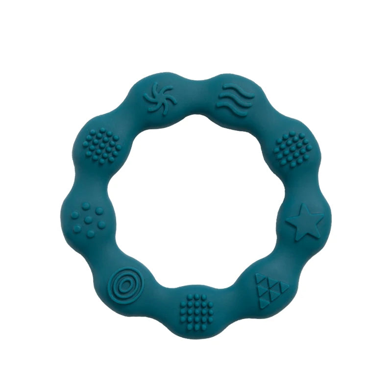 A teal circular teething ring with various raised textures, including dots, waves, and geometric shapes, designed for sensory stimulation and soothing gums.