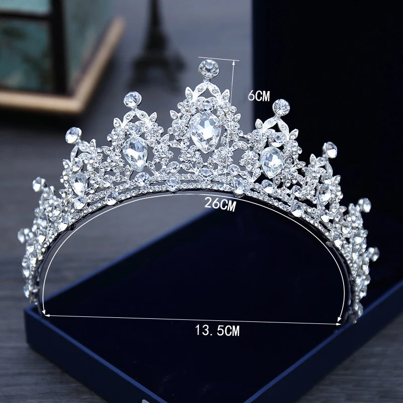 Sparkling diamond tiara in a display box, adorned with intricate jewel patterns, measuring 26 cm wide and 6 cm high, perfect for a formal occasion.