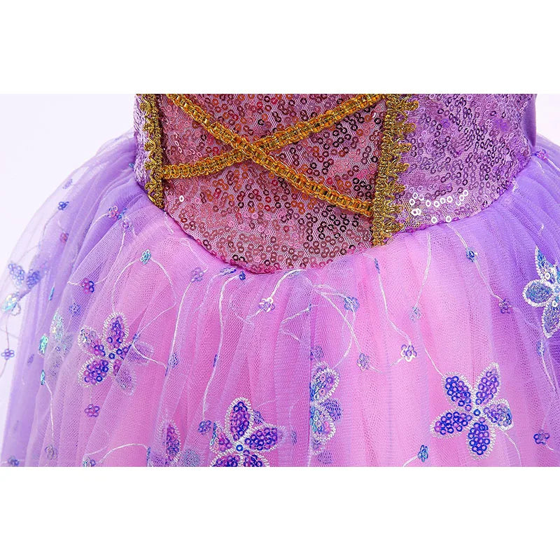 Close-up of a pink and purple dress with gold sequin details and floral embroidery on a tulle skirt.