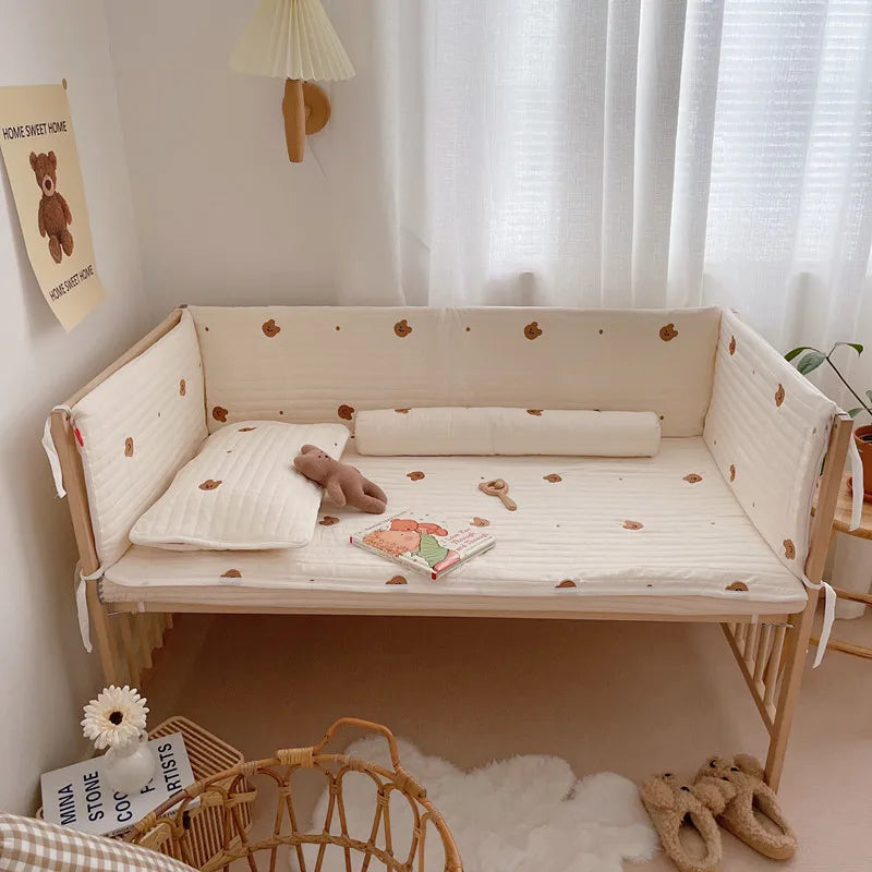 Cozy nursery corner with a teddy bear-themed bedding set on a wooden crib, plush toy, book, and rattle. A wall poster, soft lighting, and fluffy rug complete the serene setup.