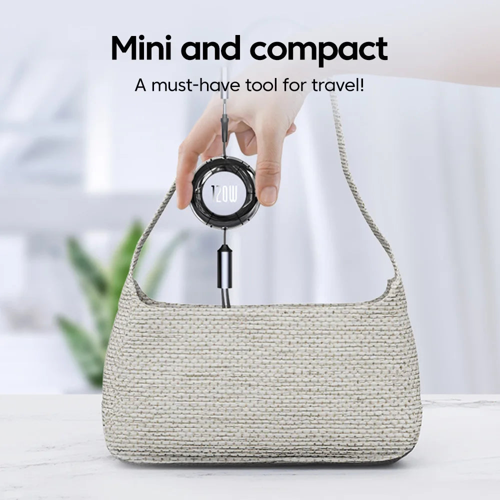 A digital luggage scale is held above a woven handbag, showing a weight of 12.0W. Text above reads "Mini and compact: A must-have tool for travel!" The background is blurred.
