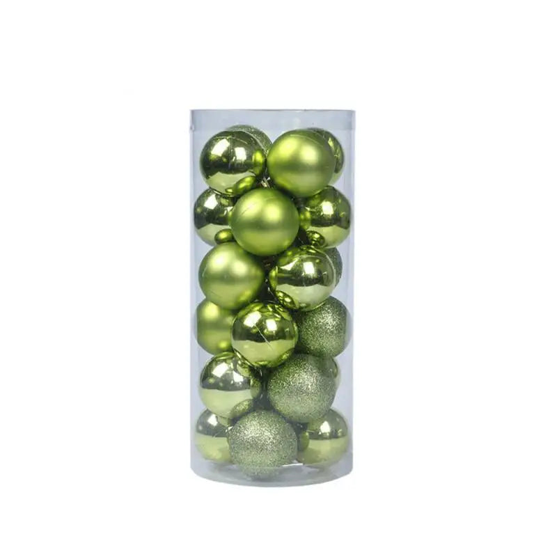 A clear cylindrical container filled with shiny and matte green Christmas ornaments, each reflecting light slightly differently.