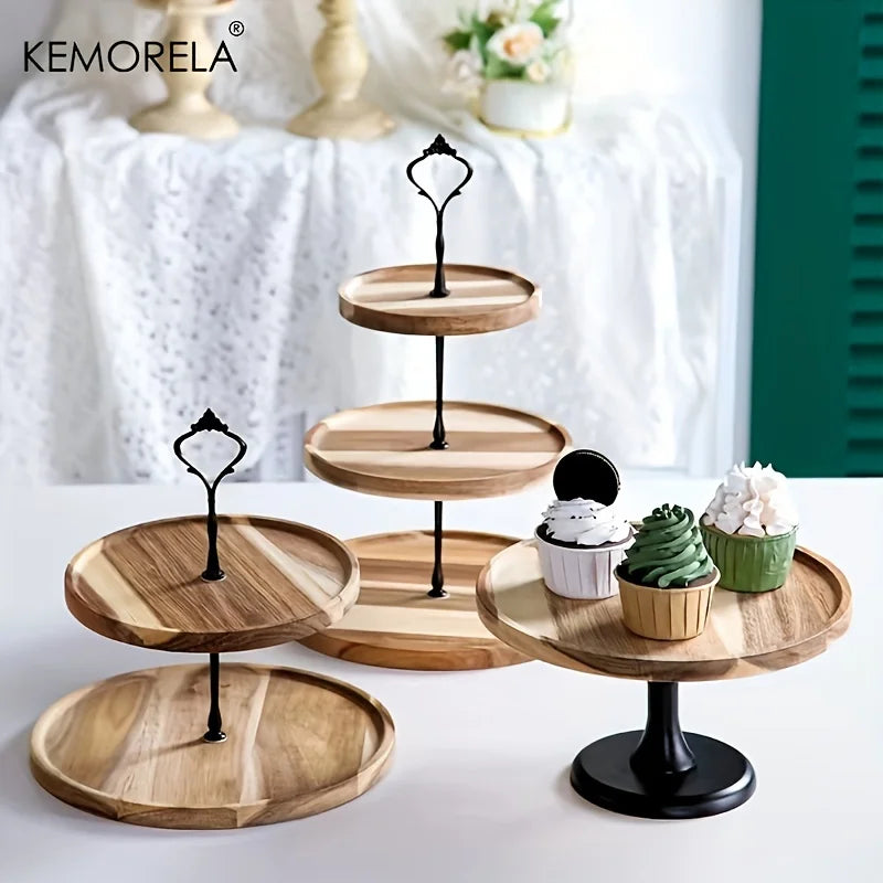 Three wooden cake stands, two two-tiered and one single-tiered, with black metal accents. Three cupcakes with cream toppings are displayed on the single-tier stand.
