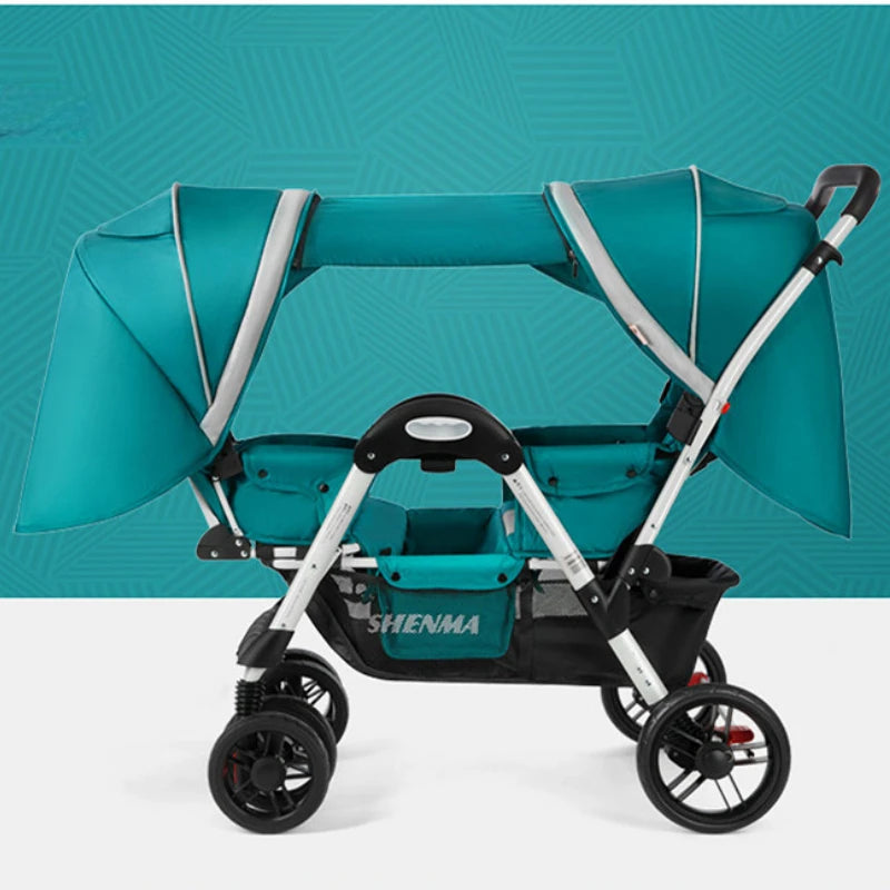 Teal twin stroller with two canopies, silver frame, and a black storage basket underneath, set against a patterned teal background.