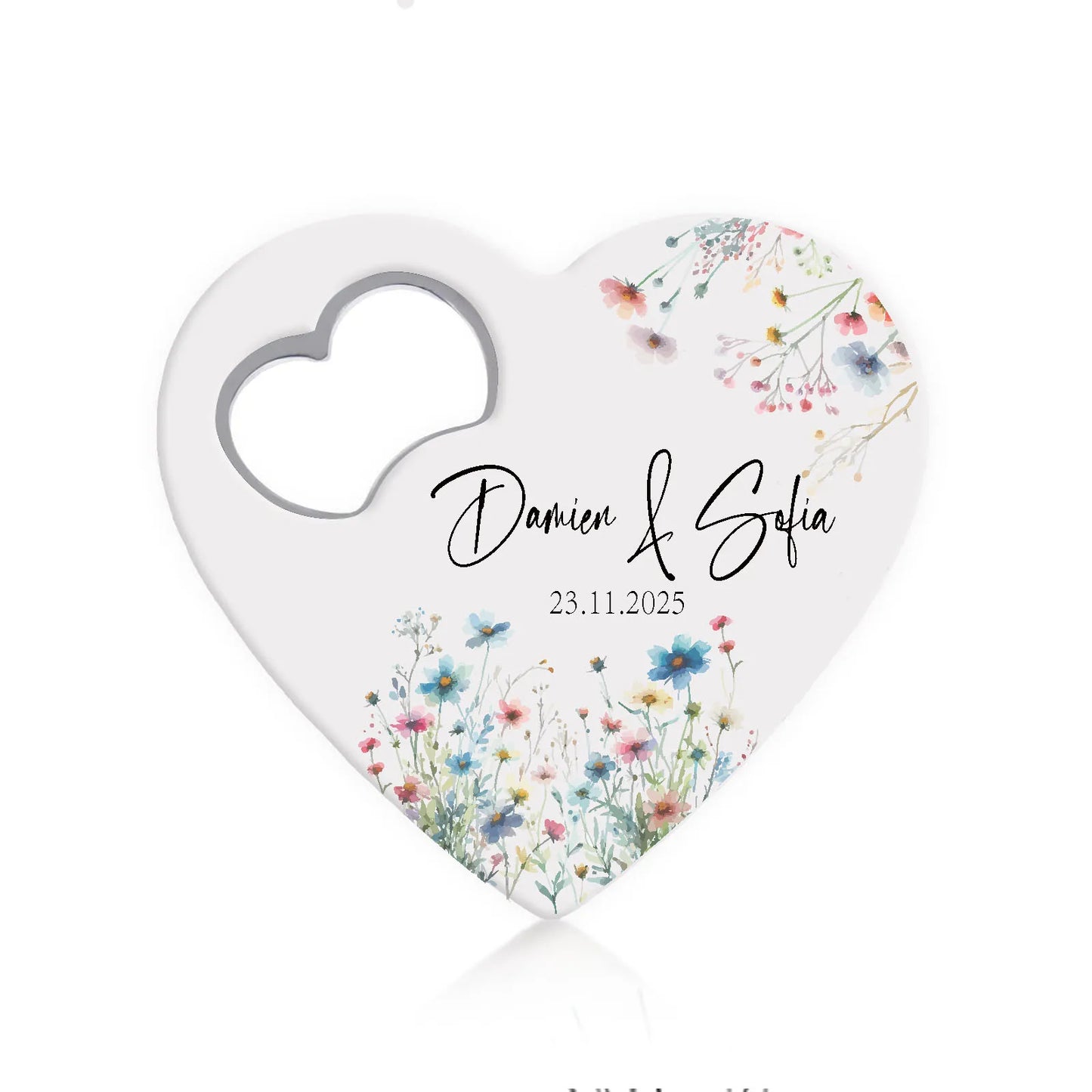 Heart-shaped card with a heart cutout, decorated with colorful wildflowers. The text reads "Damien & Sofia" with the date "23.11.2025."