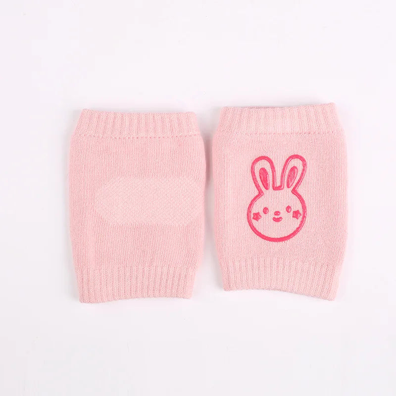 Pink children's knee pads with ribbed tops, featuring a cute pink bunny face design on one pad.