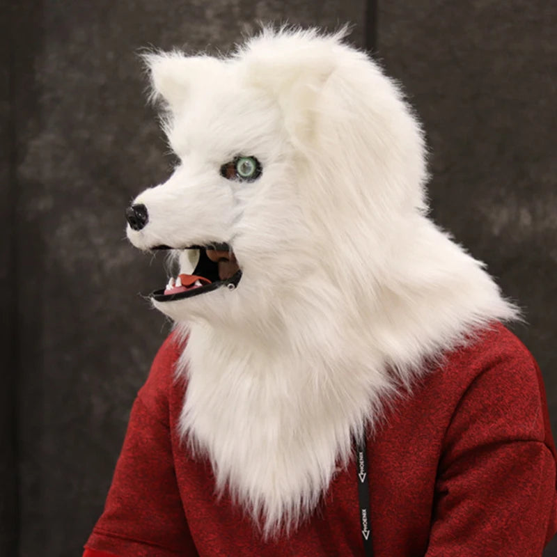 Person wearing a white, realistic wolf mask with open mouth, dark eyes, and fluffy fur. Red textured shirt adds contrast against a blurred dark background.