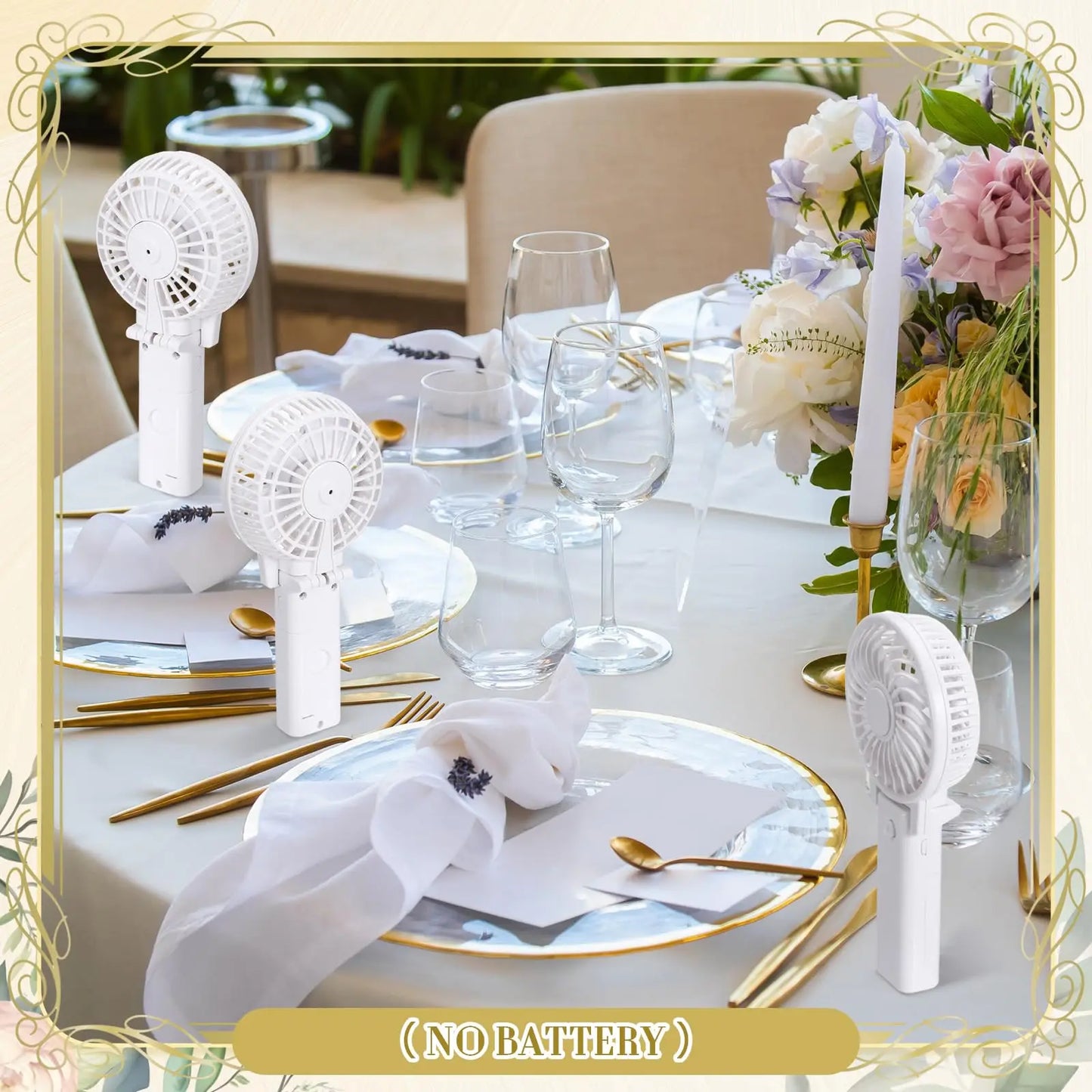 Elegant dining table setup with white fans labeled "No Battery", surrounded by gold-rimmed plates, cutlery, folded napkins, glassware, and a floral centerpiece with candles.