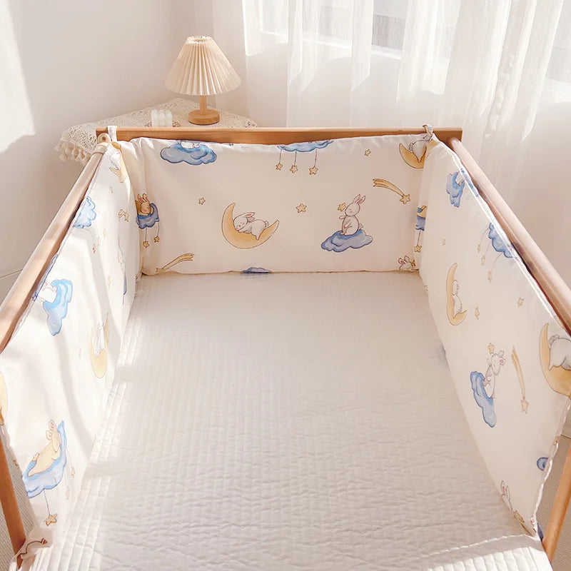 Wooden crib with pastel bedding featuring bunnies on clouds and stars, under soft sunlight. A small lamp on a lace-covered table in the corner completes the serene setting.