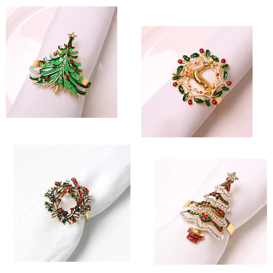 Four festive napkin rings: a green Christmas tree, a golden deer in a wreath, a red and green wreath with berries, and a jeweled Christmas tree with a gold base.