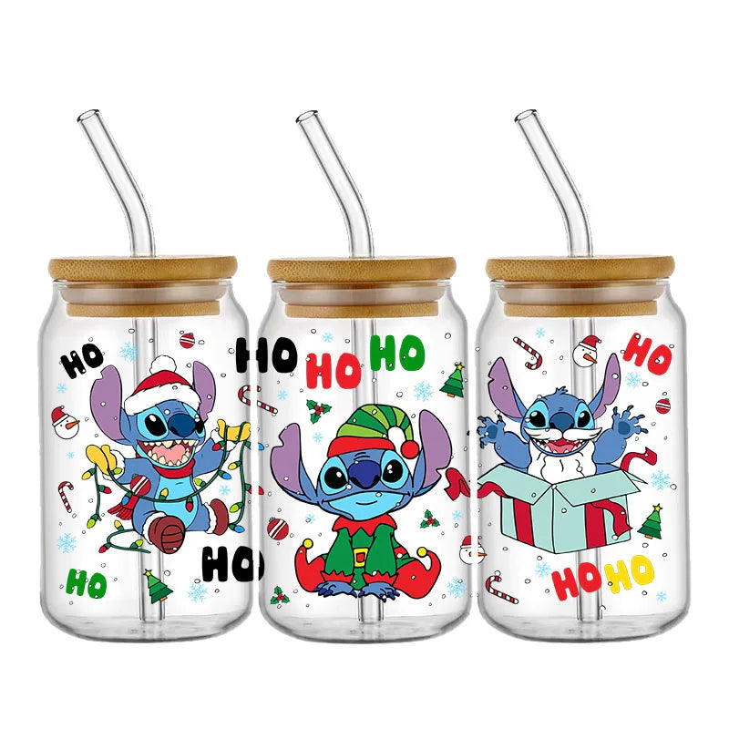 Three Christmas-themed glass jars with bamboo lids and straws feature a blue alien character in festive attire, surrounded by holiday decorations and "Ho Ho Ho" text.