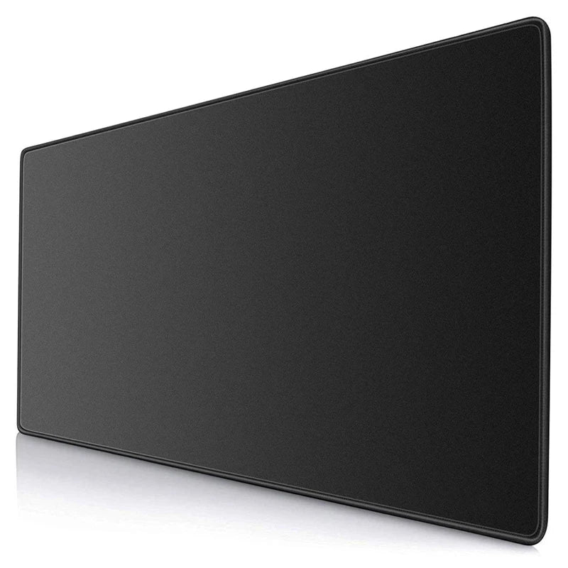 Large black desk mat with smooth surface and stitched edges, positioned at an angle. Suitable for keyboards and mice, offering a sleek and minimalistic look.