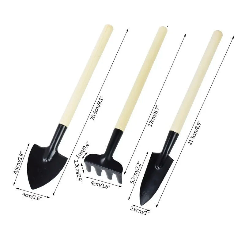 Three miniature gardening tools with wooden handles: a spade, a rake, and a trowel. Each tool shows precise measurements for handle and head length in centimeters and inches.