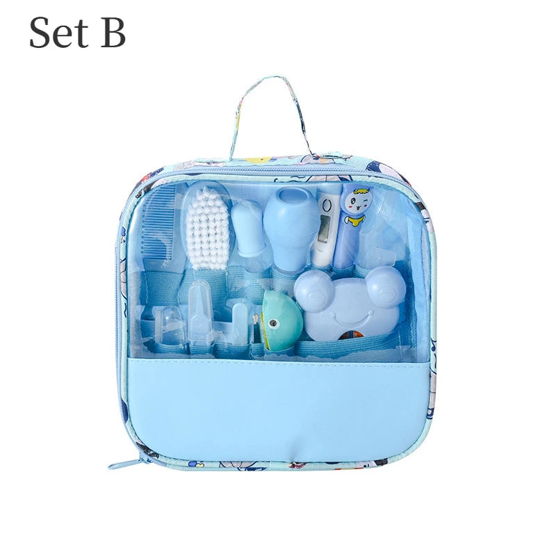 Blue baby grooming kit with brush, nasal aspirator, thermometer, scissors, and clippers in a clear zippered pouch labeled "Set B."