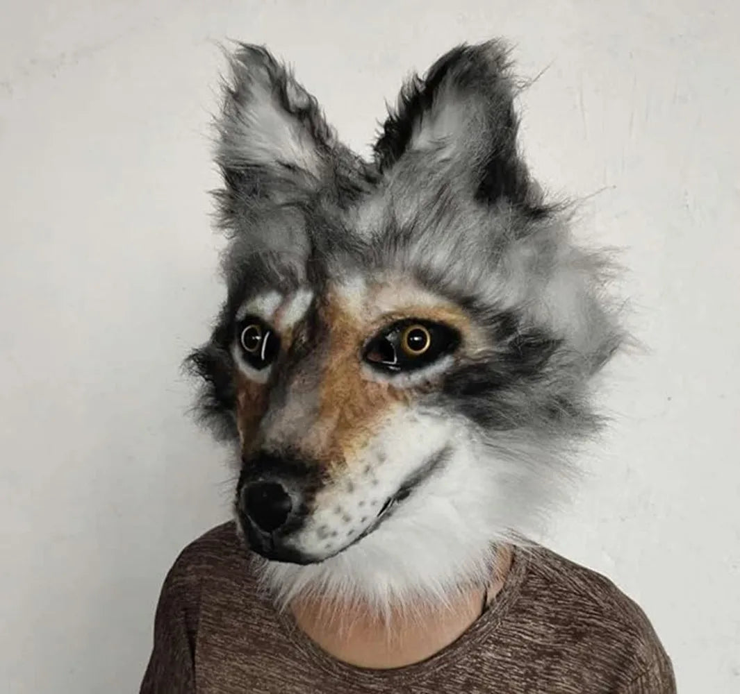 Person wearing a realistic wolf mask with detailed fur and lifelike eyes, set against a plain background.