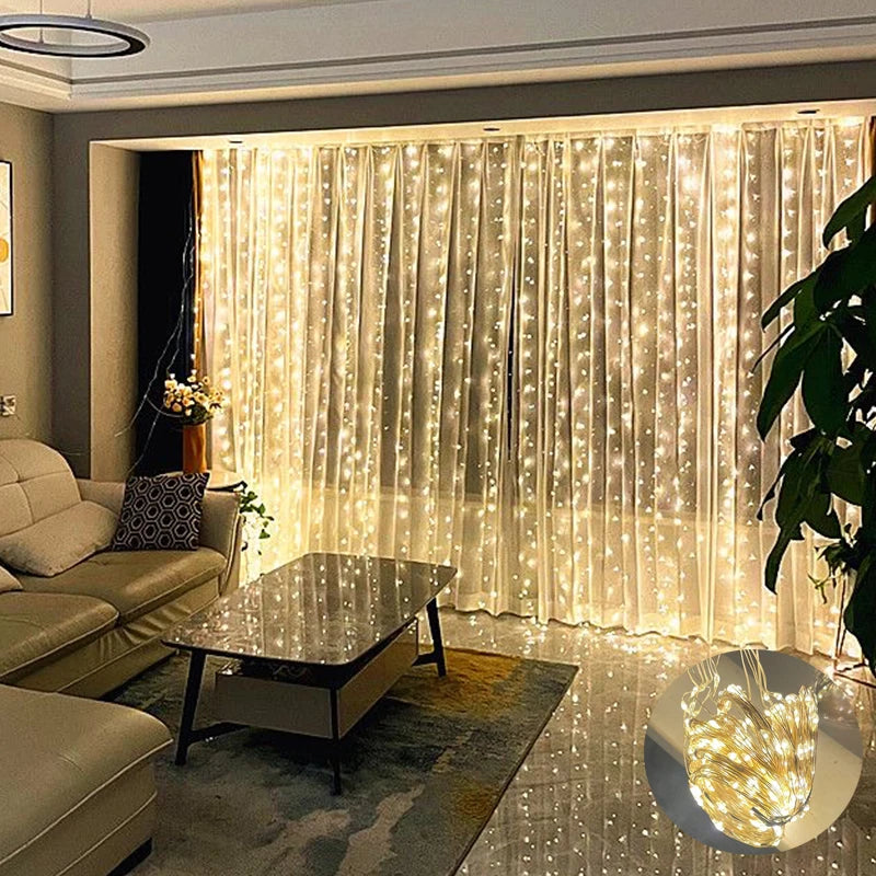 A cozy living room with a beige sofa, patterned cushion, and coffee table. The wall features sheer curtains adorned with warm white string lights, creating a soft, ambient glow.