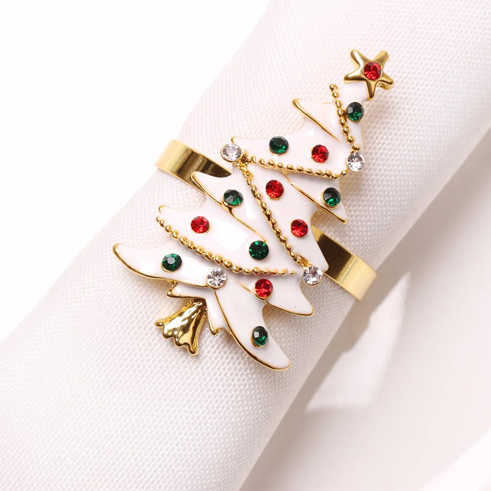 Festive napkin ring featuring a gold and white Christmas tree adorned with red and green gems and a gold star, wrapped around a white napkin.