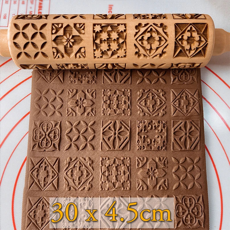Embossed rolling pin with intricate geometric and floral patterns impressing designs onto brown dough, measuring 30 x 4.5 cm, on a marked pastry mat.