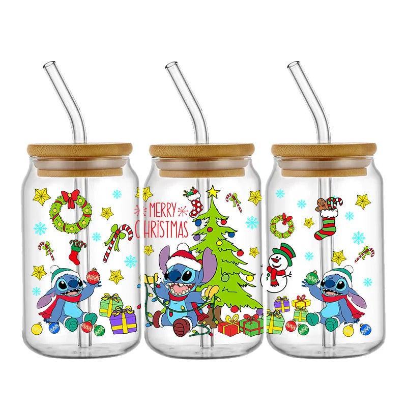 Three glass jars with bamboo lids and straws, featuring festive Christmas designs with an animated blue character, wreaths, gifts, and a snowman, surrounded by stars and candy canes.