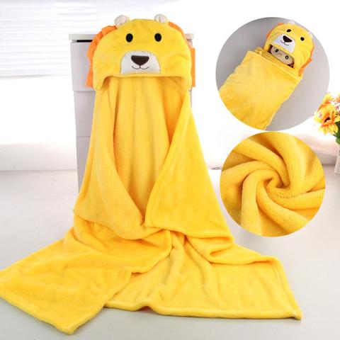 Yellow hooded baby blanket with a lion design, featuring ears and a face. Insets show a baby wrapped in the blanket and a close-up of the soft fabric texture.
