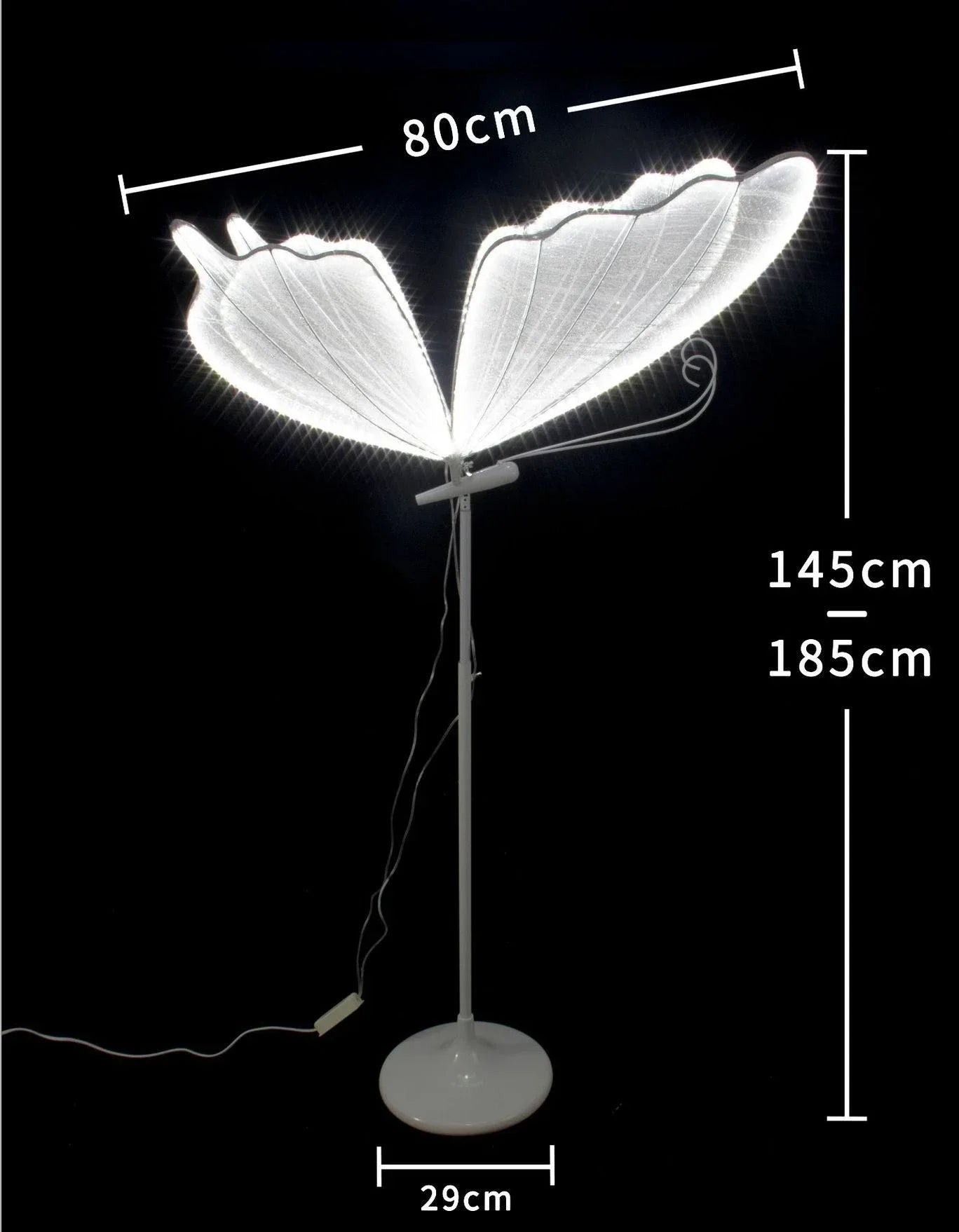 Elegant wing-shaped floor lamp with a white base, standing 145-185cm tall, wingspan of 80cm, and base diameter of 29cm. Emits a soft glow, ideal for ambient lighting.