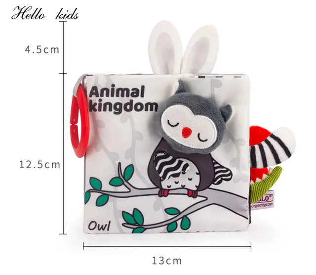 Soft baby cloth book titled "Animal Kingdom" with an owl design. Includes plush owl, bunny ears, and red teething ring. Dimensions: 12.5x13x4.5 cm.
