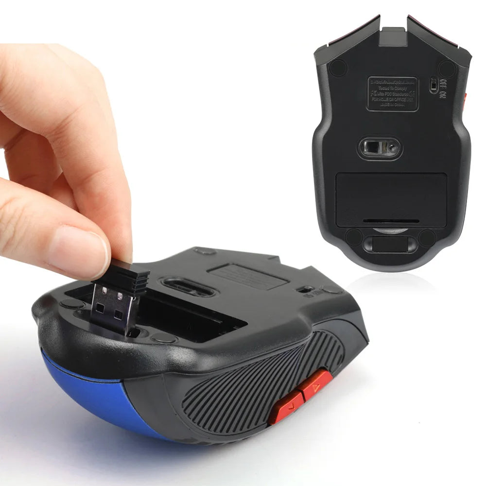 A close-up of a black and blue wireless mouse with red buttons. A hand is inserting a small USB dongle into the bottom compartment. A mouse appears in the background, flipped to show its base.
