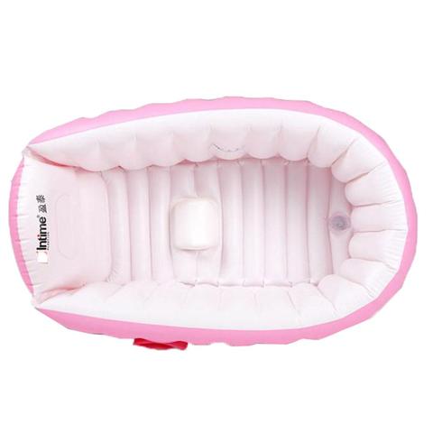 Inflatable pink and white baby bathtub viewed from above, with a cushioned base and backrest, featuring a small pillow. The material appears soft, ensuring comfort and safety.