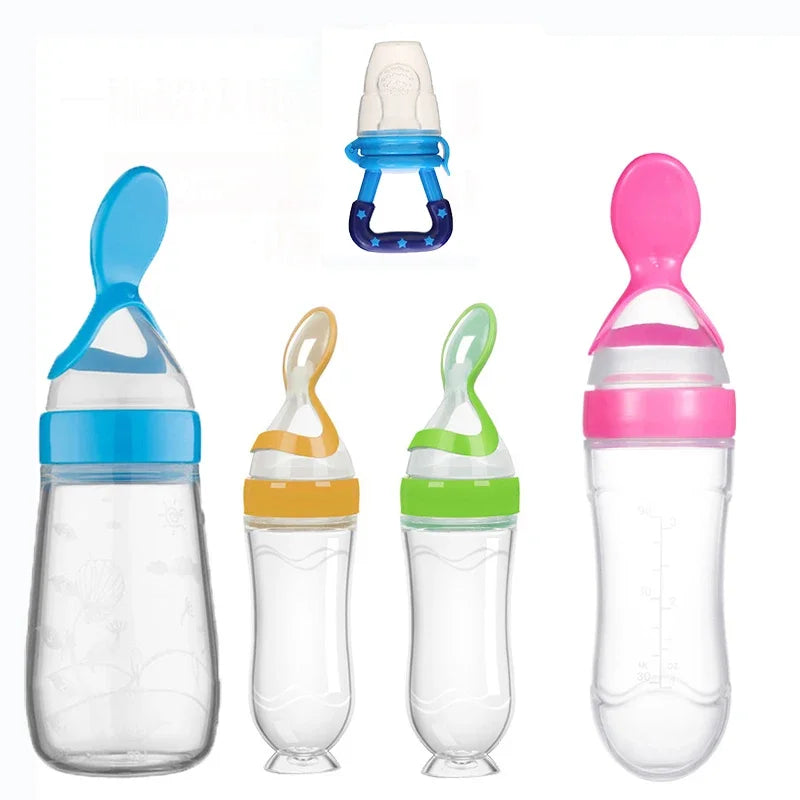 Five baby feeding bottles with colorful lids are displayed. The bottles are in shades of blue, yellow, green, pink, and a blue pacifier with stars is above them.