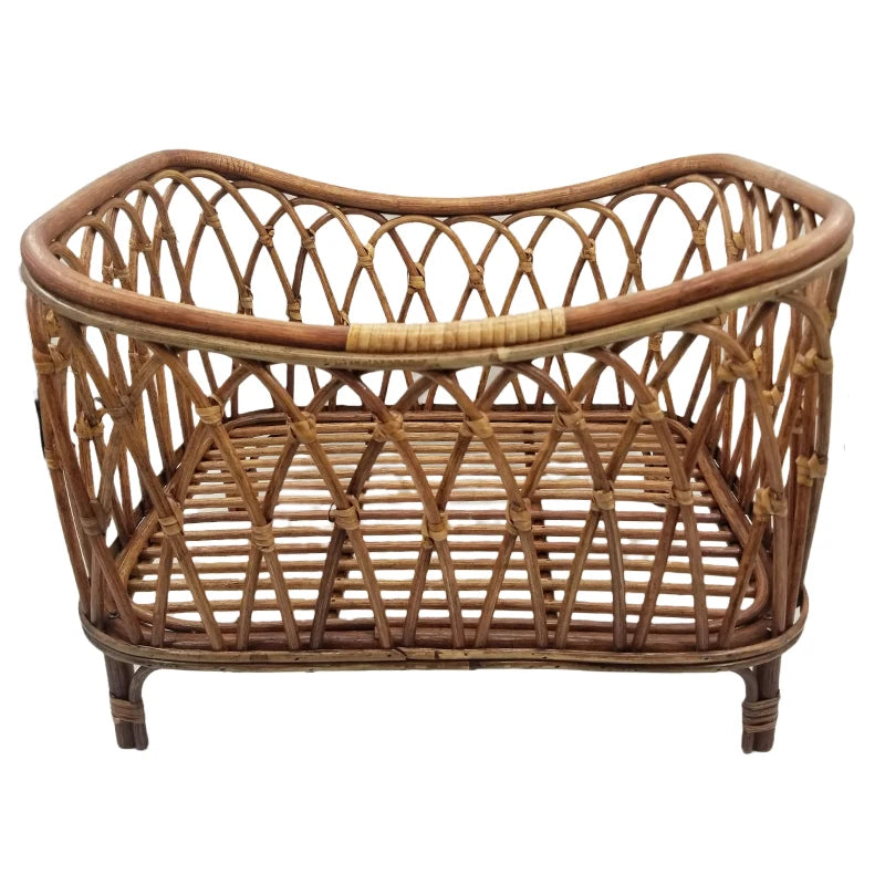 A small, woven rattan basket with a lattice pattern and sturdy legs. The design features an open, crisscross weave with a curved top edge, ideal for decorative purposes.