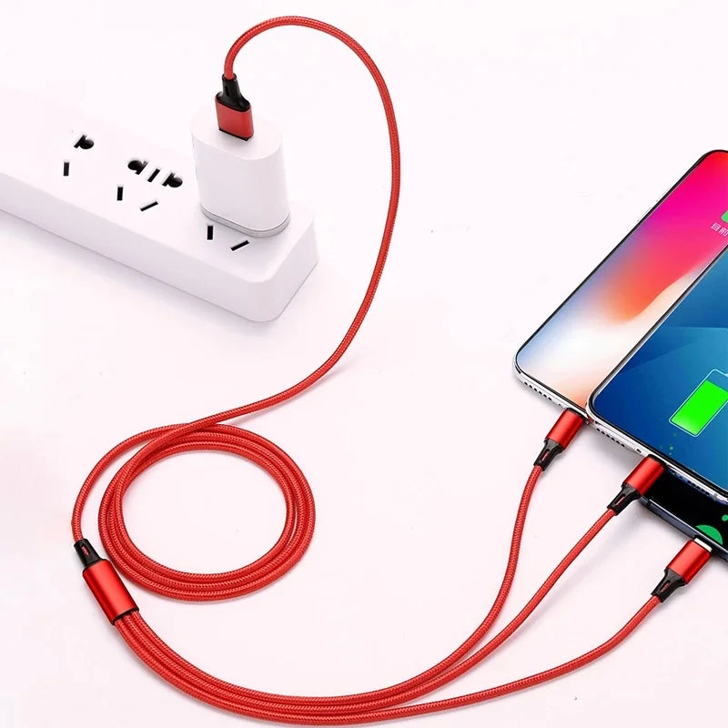 A red multi-device charging cable is plugged into a power strip, charging two smartphones. The phones show charging icons, and the cable is neatly coiled on a white surface.