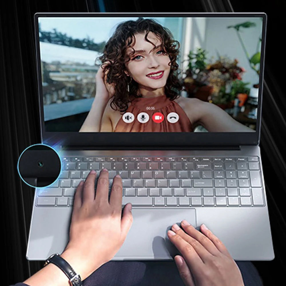 Person video calling on a laptop showing a smiling woman on screen, with buttons for call controls visible. Hands rest on the keyboard and touchpad, wearing a watch.