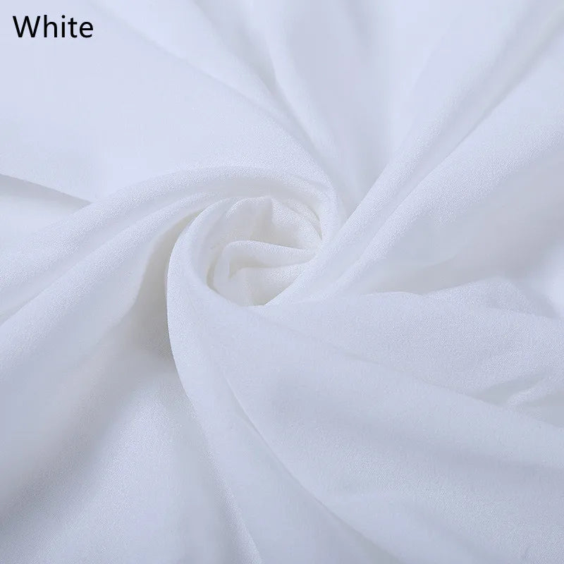 Close-up of soft white fabric gathered in a spiral pattern, showing texture and folds. A text label in the top left corner reads "White."
