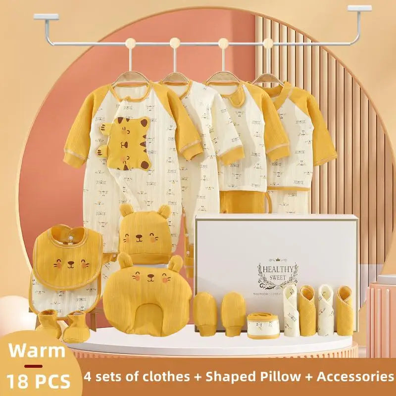 Baby gift set with 18 pieces, including four sets of yellow and white clothes with animal prints, a bear-shaped pillow, bib, booties, mitts, and a gift box labeled "Healthy Sweet."
