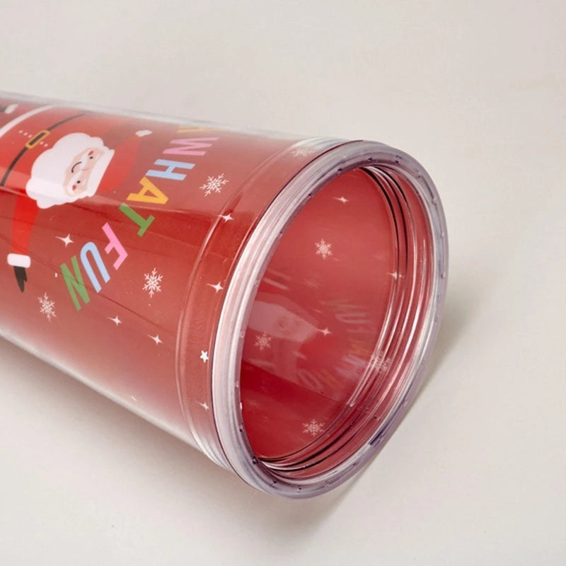 Red tumbler with Santa Claus design, snowflakes, and "HAVE FUN" text. The transparent lid is at the base, showing the cheerful holiday-themed exterior.