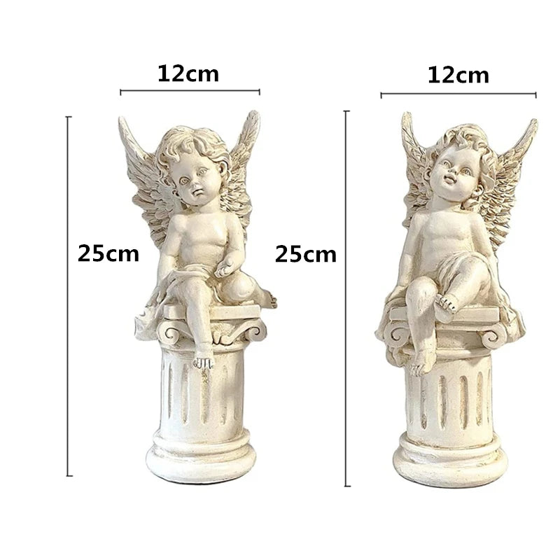 Two white angel statues sit on columns. Each is 25 cm tall and 12 cm wide. They have wings and curly hair, with one holding an object. Both are featured in a side-by-side view.