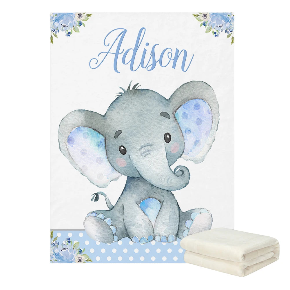 Cute gray elephant illustration with blue ears and cheeks on a blanket. Floral and polka dot accents. Name "Adison" in script above. Folded blanket shown at the bottom right.