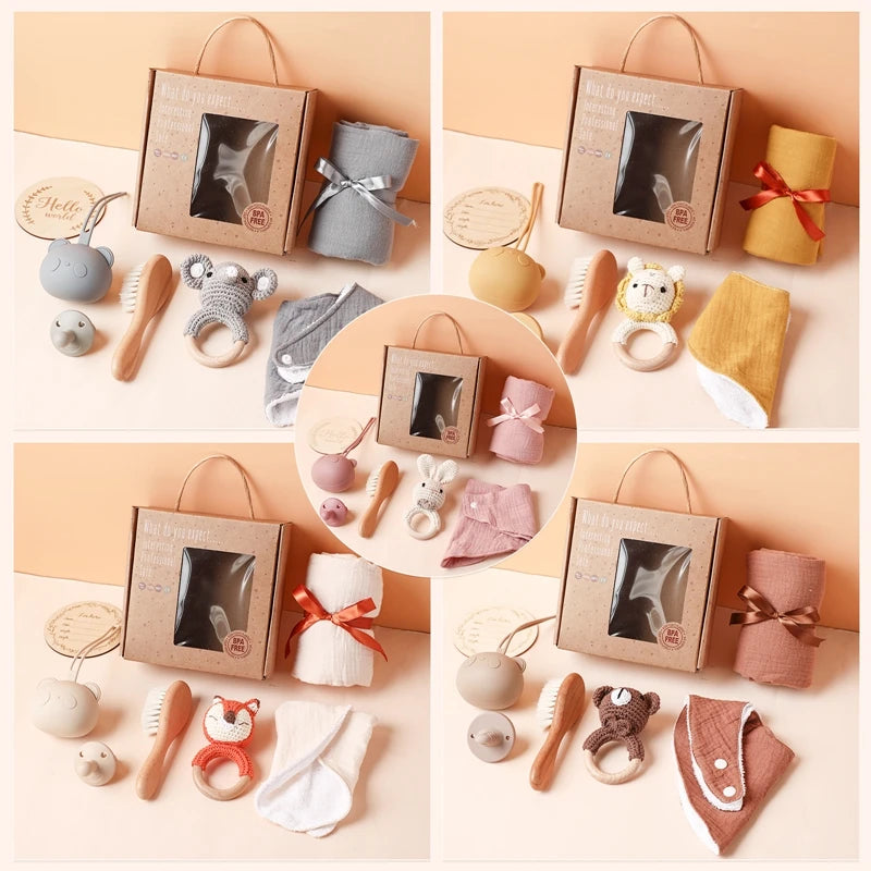 Gift sets for babies include soft toys, pacifiers, brushes, cloths in various colors, and boxed packaging. Each set features different animal-themed designs and fabric colors.