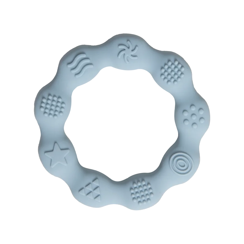 A light blue silicone teething ring with various textured patterns, including wavy lines, dots, and stars, designed for sensory stimulation and teething relief.